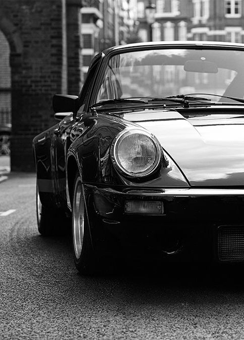 a black and white photo of a car parked on the street