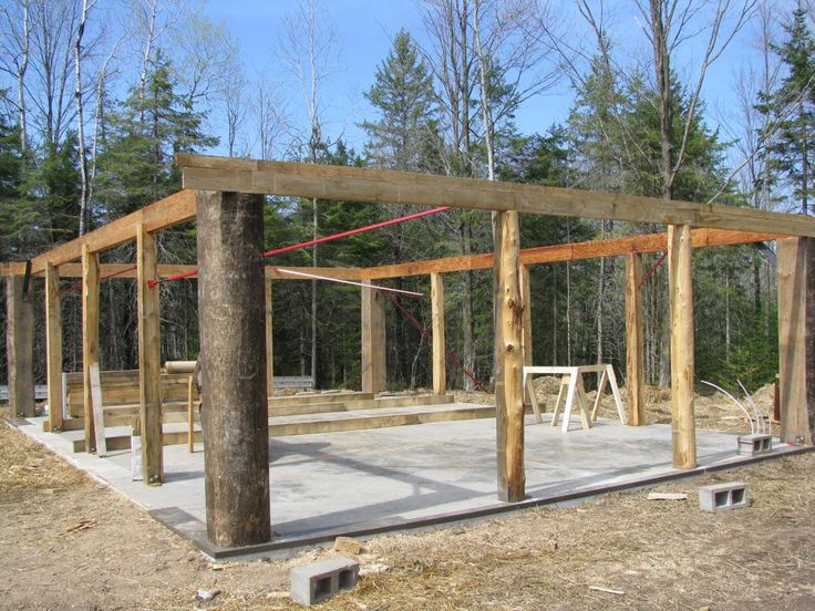 a wooden structure in the middle of a forest