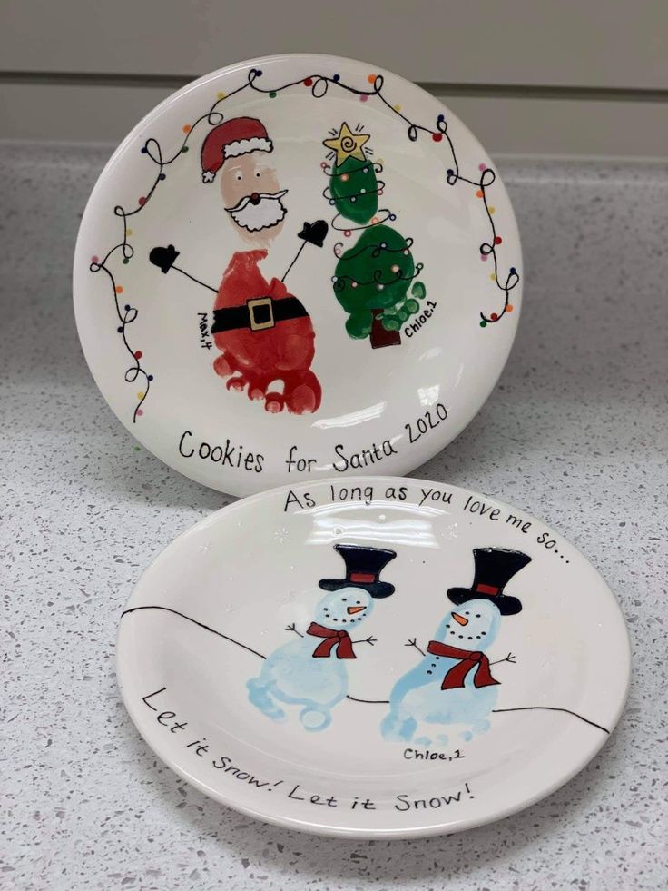 two christmas plates with santa and snowmen on them