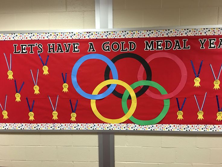 a banner that says let's have a gold medal year in front of a wall