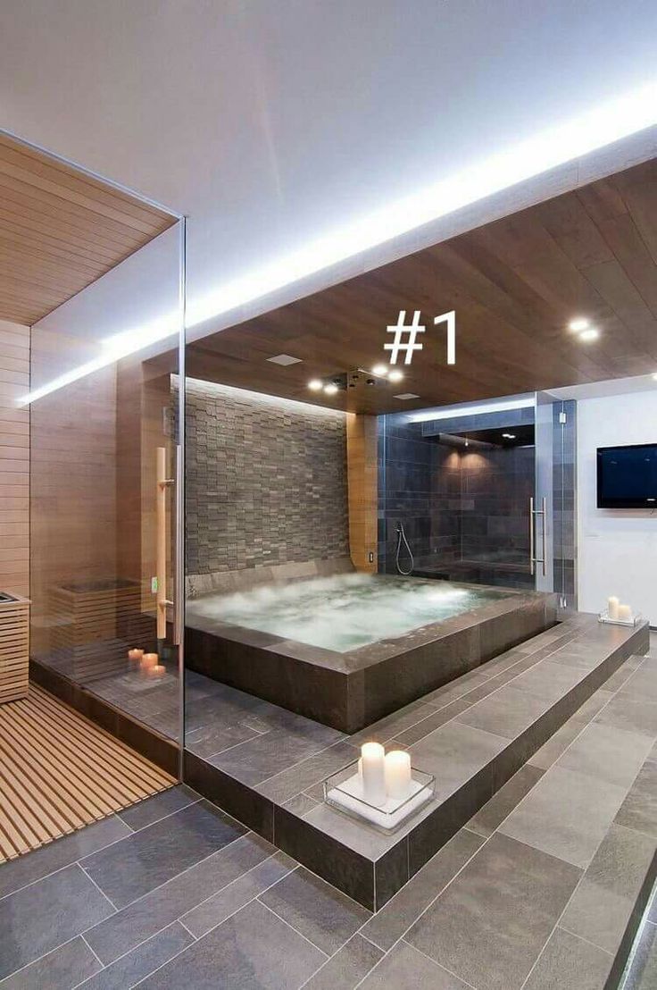 a bathroom with a large jacuzzi tub next to a television