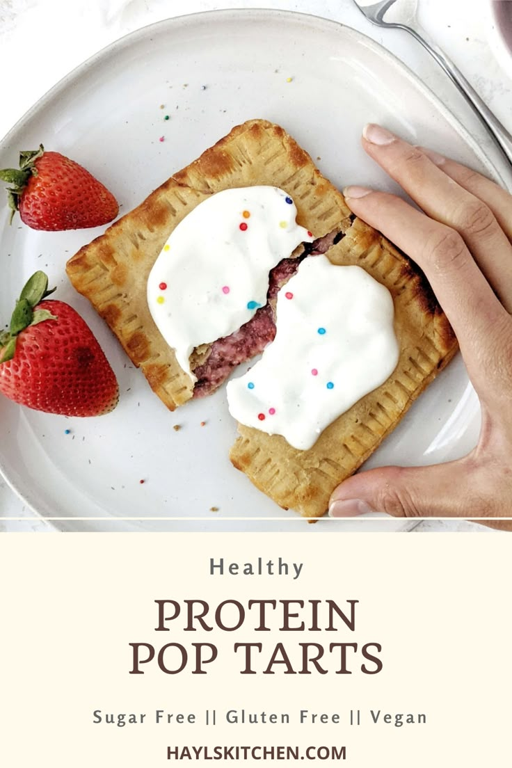 a person holding a piece of pie on top of a white plate with strawberries