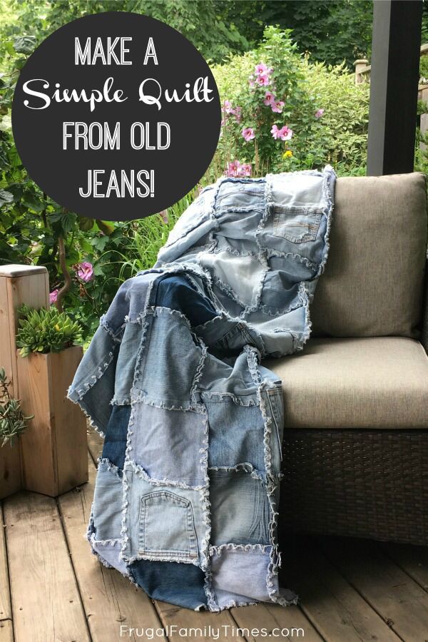 an old jean jacket sitting on top of a wooden deck