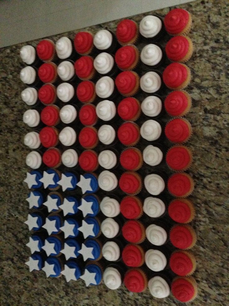 cupcakes with red, white and blue frosting are arranged in the shape of an american flag