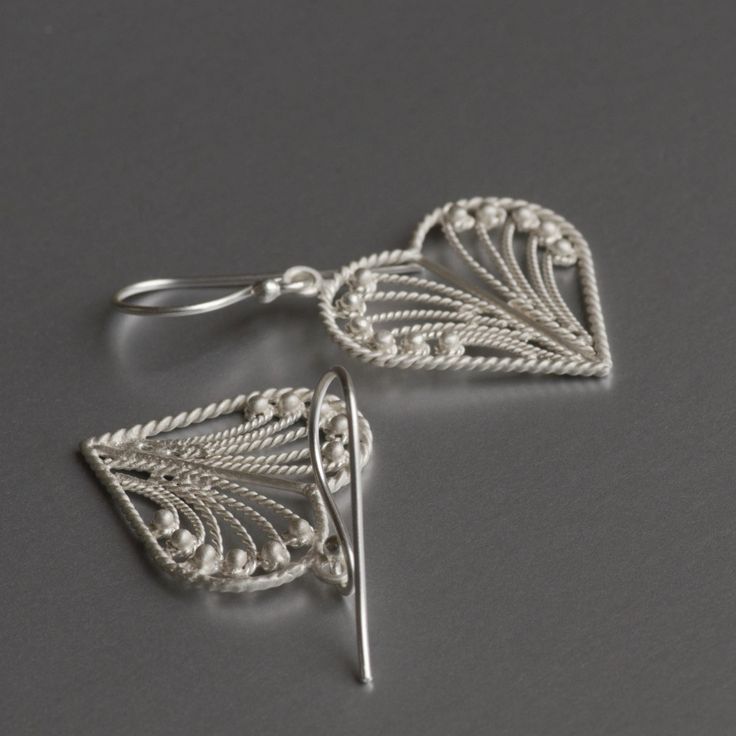 Featherweight, heart-shaped, filigree work, dainty earrings with hand-hammered texture, these cute little delicate yet durable earrings are sure to win your heart and others around you. Fun and playful, these popular earrings are simple and clean for an effortless style that can go with anything. The most popular pair of earrings sold in 2021. Did you know that sterling silver tarnishes simply by being in contact with air, it is advisable to store your silver jewelry either in a cloth pouch or a Wedding Heart-shaped Drop Earrings In Sterling Silver, Handmade Elegant Heart Drop Earrings, Elegant Handmade Heart Drop Earrings, Elegant Filigree Heart Earrings, Silver Dainty Heart Earrings For Wedding, Elegant Heart Filigree Earrings, Elegant Silver Teardrop Heart Earrings, Elegant Open Heart Filigree Jewelry, Handmade Elegant Heart Earrings For Anniversary