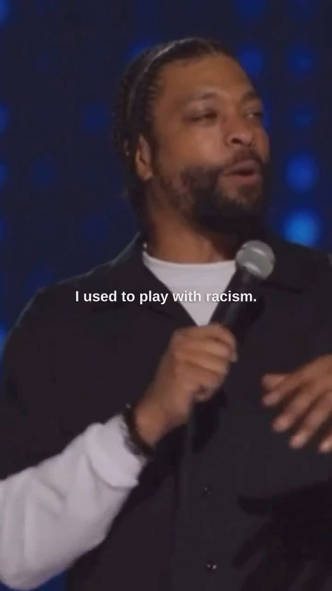 a man standing in front of a microphone with the words i used to play with racism