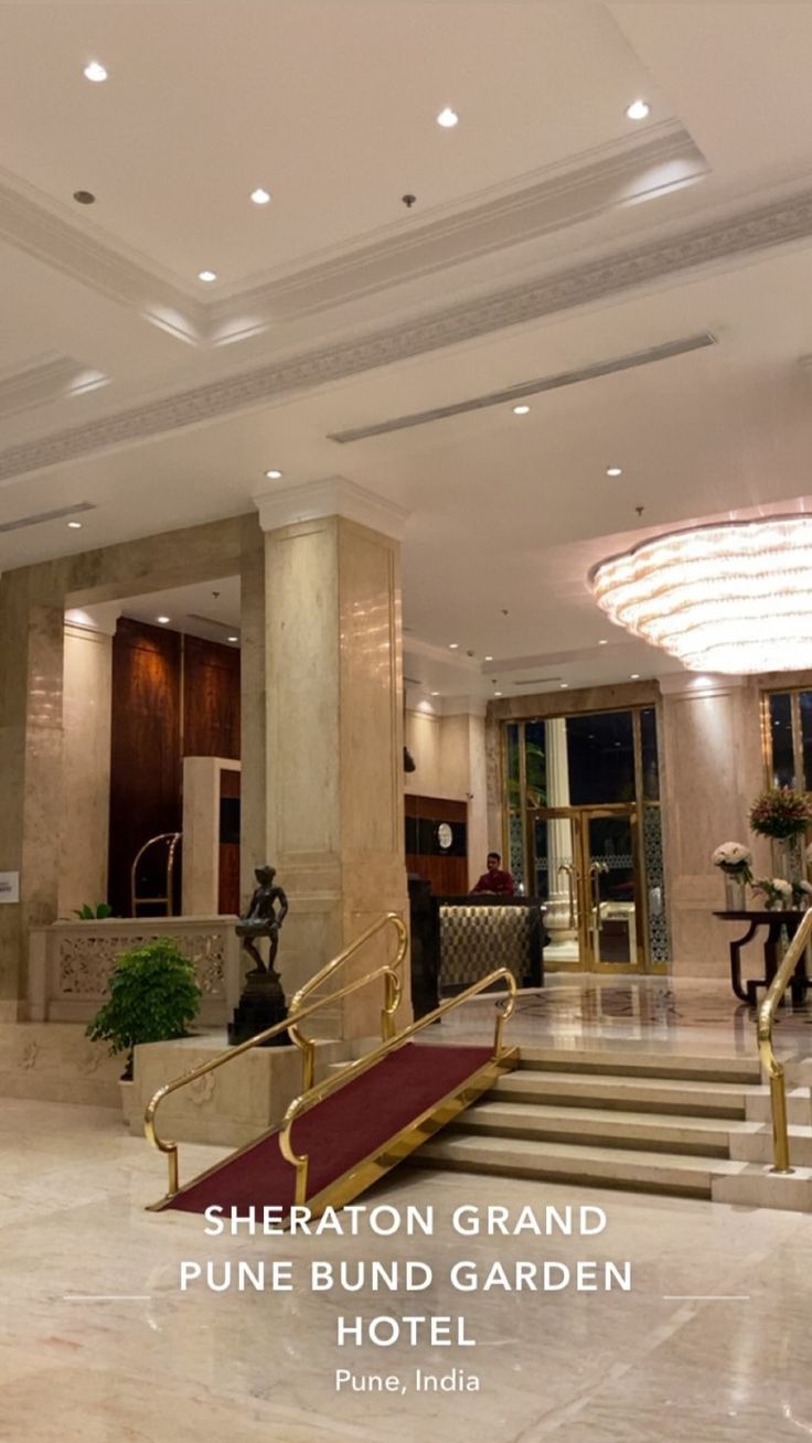 there is a hotel lobby with stairs leading up to the entrance