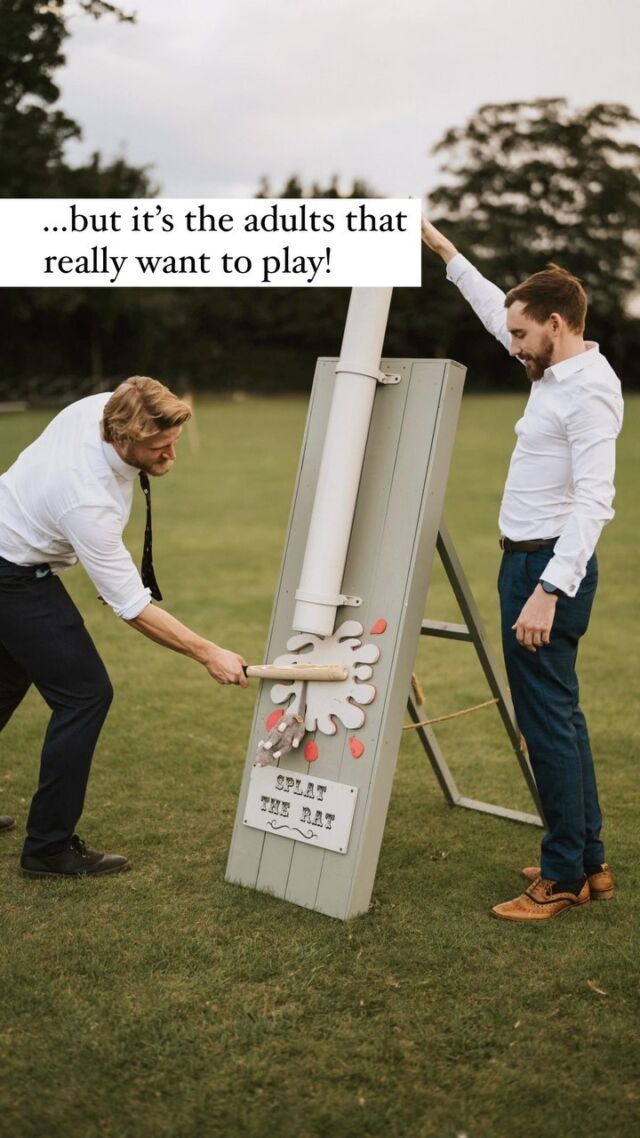 two men standing next to each other near a sign that says, but it's the adults that really want to play