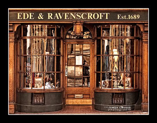 an old fashioned store front with glass windows