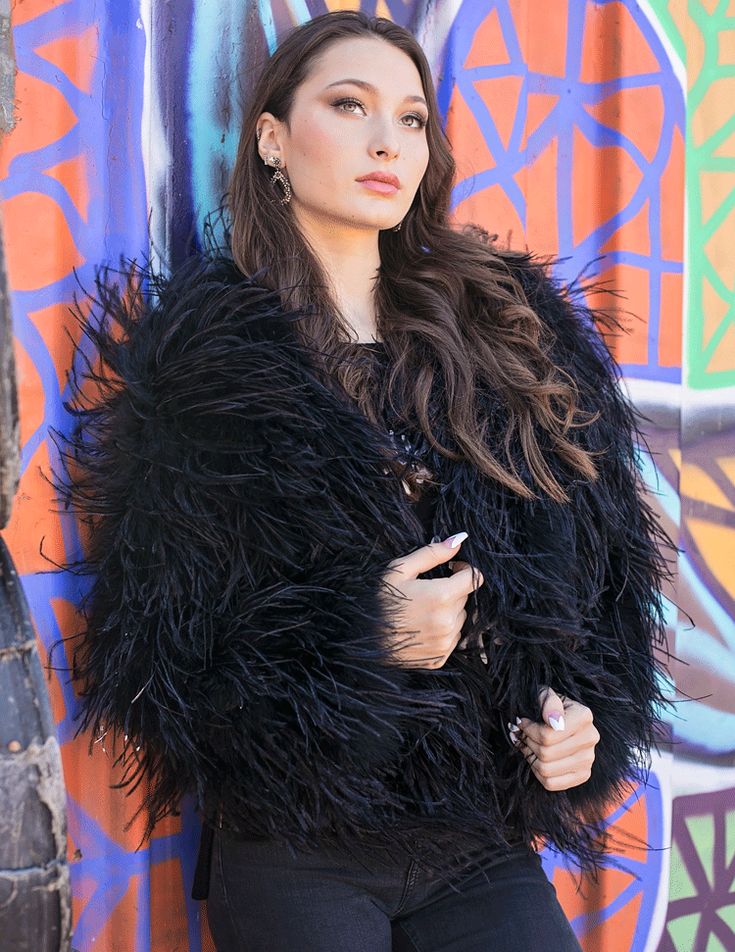 She exudes elegance but is never ostentatious. She is composed and coy, regal and refined - always the lady. The Paris Ostrich Feather Jacket is a striking Jet Black colored jacket for those wanting to make a statement. Whether your that urban chic type of girl that loves to throw on your favorite boyfriend jeans, a cool tee & kicks or a lady that embraces elegance, grace and finesse with polished style or a gorgeous winter bride be sure to find your special piece to compliment all wardrobes. Ha Ostrich Feather Jacket, Luxury Black Outerwear With Faux Fur Trim, Black Fur Coat With Feather Trim Long Sleeve, Luxury Black Leather Jacket With Faux Fur Trim, Luxury Black Faux Fur Outerwear, Jet Black Color, Feather Jacket, Polished Style, Wedding Jacket