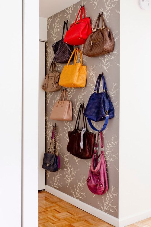 the purses are hanging up on the wall