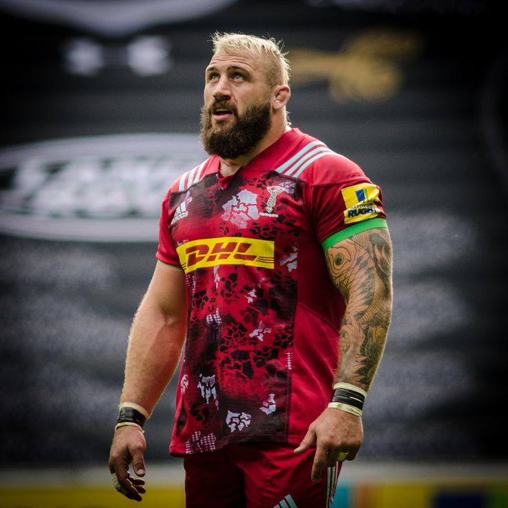 a man with a beard wearing a red jersey