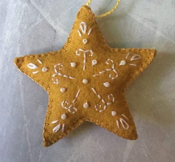 an ornament shaped like a star with musical notes on it