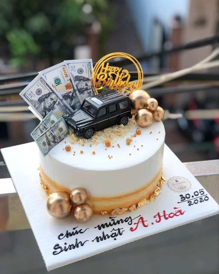 a cake decorated with money and a car on top