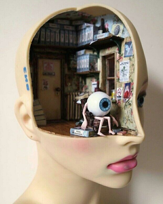 a human head with an eyeball in the shape of a doll's head