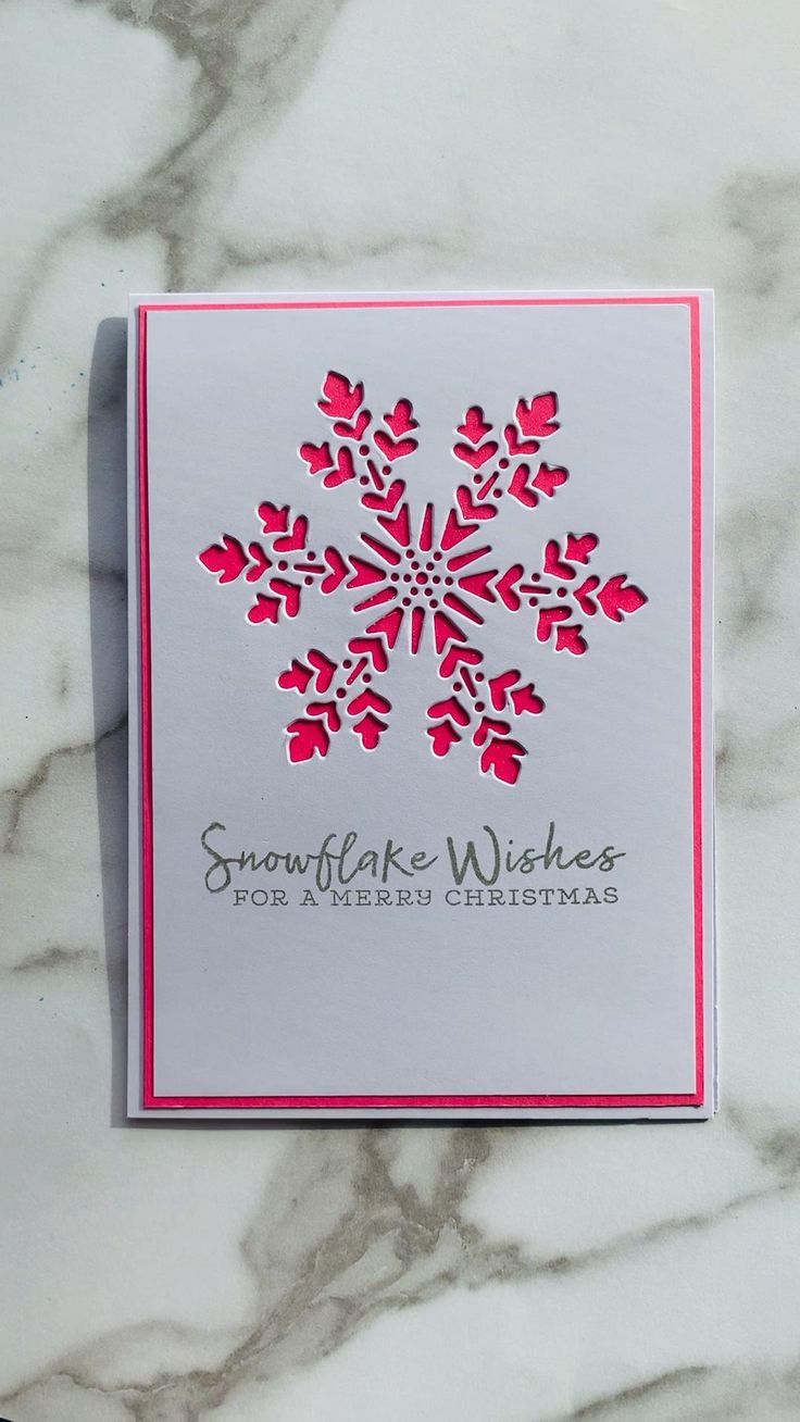 a snowflake wishes card on a marble surface