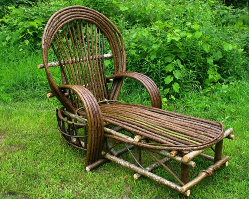 a chair made out of bamboo sitting in the grass