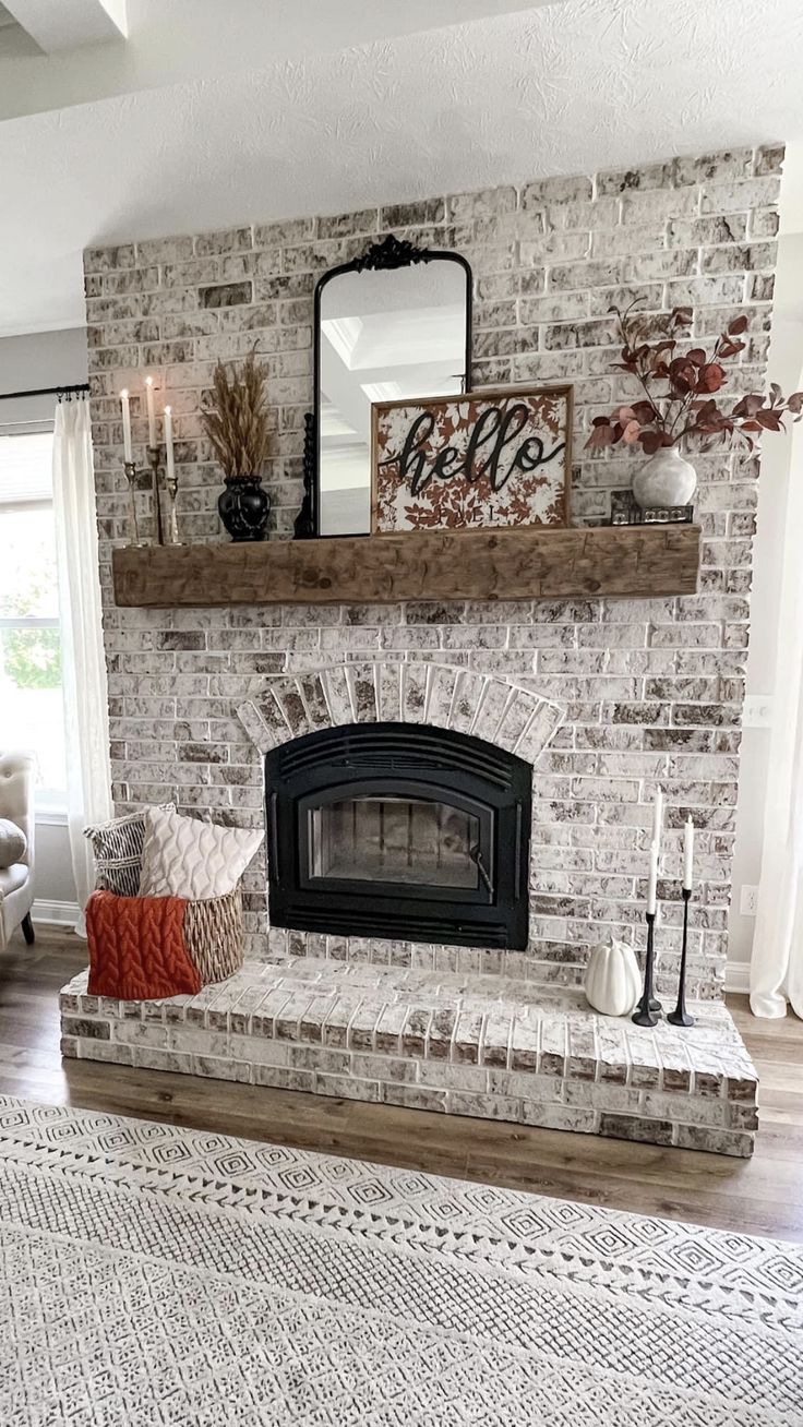 a living room with a brick fireplace and white rug