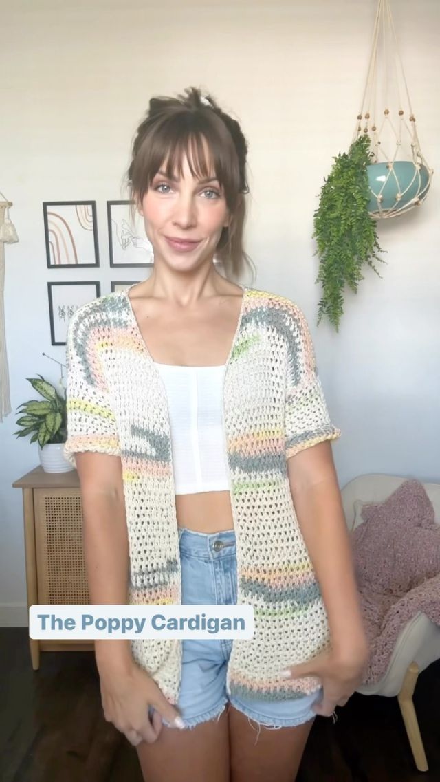 a woman standing in front of a white wall