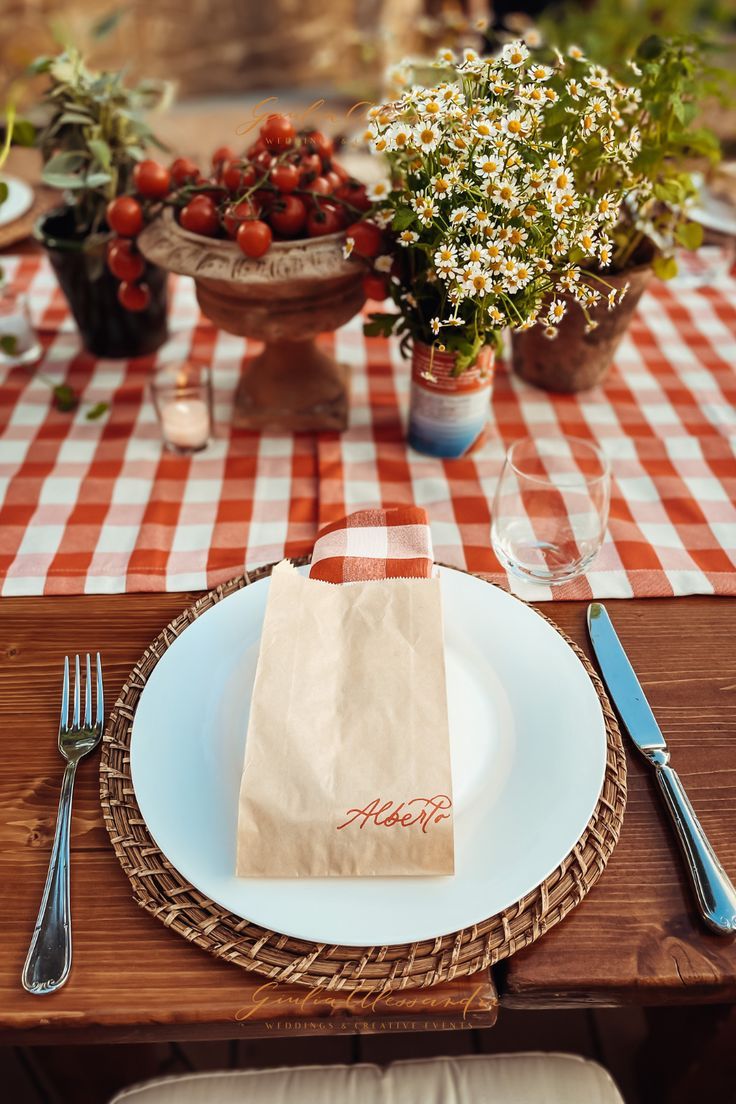 a table set with plates, utensils and napkins