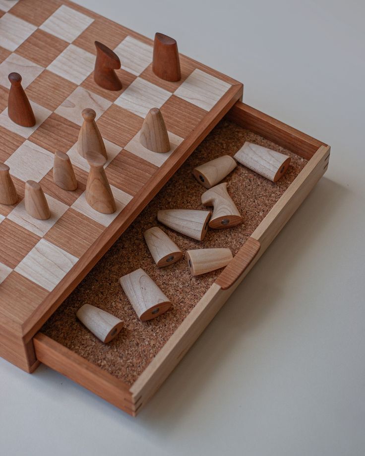 a wooden chess board with pieces in it