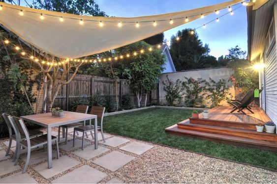 an outdoor patio with string lights strung over it