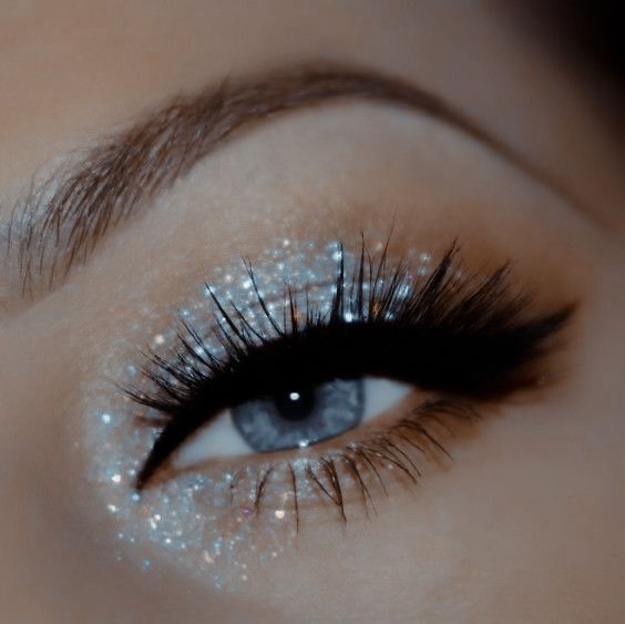 Glittery Black Eyeshadow, New Year’s Eve Makeup Glitter, Cute Makeup Looks For Homecoming, Silver Eyeliner Ideas, Grey Eyeshadow Looks Blue Eyes, Makeup Looks For A Silver Dress, Eyeshadow Ideas For White Dress, Silver Eye Makeup With Rhinestones, Prom Makeup Looks For Black Dress Blue Eyes