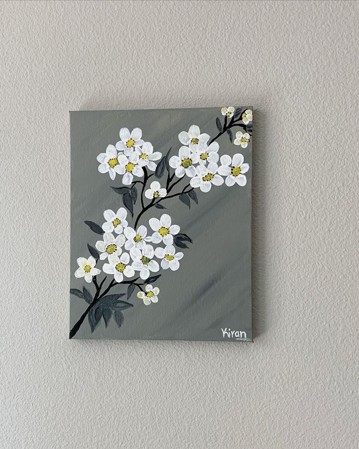 a painting of white flowers on a gray background with the word vegan written below it