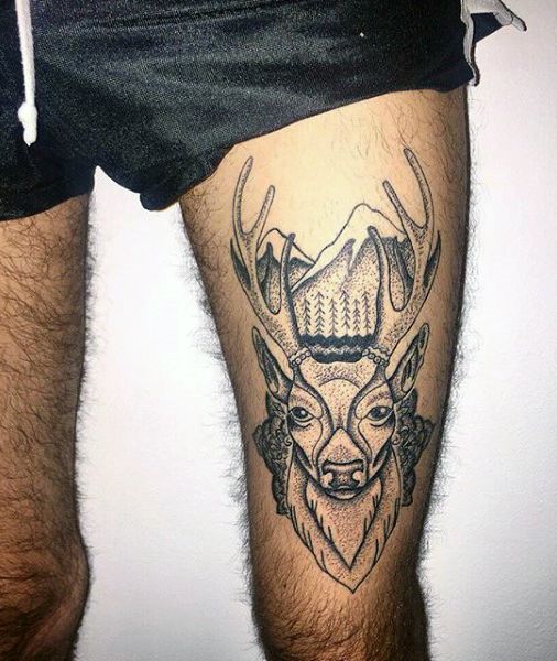 a man's leg with a deer head tattoo on the side of his thigh