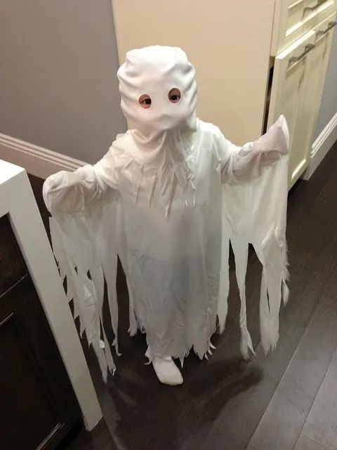 a person in a ghost costume standing on the floor