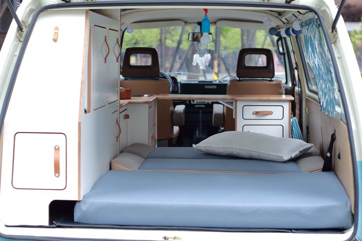 the back end of a van with a bed in it