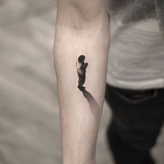 a person with a small tattoo on their arm