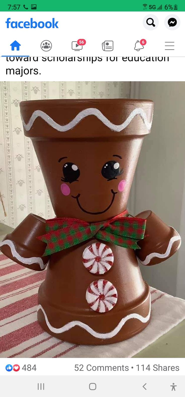 a large pot that has a gingerbread man on it's face and is decorated with candy canes