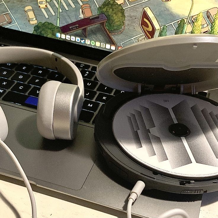 an open laptop computer with headphones on it