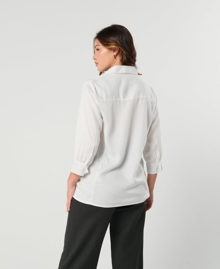 Our white maternity button down shirt with easy nursing access is a MARION exclusive design. A woman doesn't need a lot in her maternity work clothes wardrobe, This gorgeous, sustainable TENCEL workwear classic is a must-have. Its cool-touch fabric is comfortable even in warm weather. Subtle cuff detailing elevates its timeless design. Its hidden front panel ensures the buttons near your (probably growing) bust stay closed. *Buying maternity work clothes online shouldn't be stressful! We offer f Business Casual Button-up Blouse With Roll-up Sleeves, Classic White Blouse With Roll-up Sleeves, Relaxed Fit Blouse With Roll-up Sleeves For Business Casual, Office Blouse With Roll-up Sleeves And Spread Collar, Collared Office Blouse With Roll-up Sleeves, Office Blouse With Collared Roll-up Sleeves, White Collared Blouse With Placket, Office Blouse With Roll-up Sleeves And Collared Shape, White Blouse With Collared Neckline And Placket