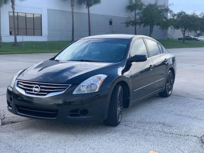 a black car parked in front of a building