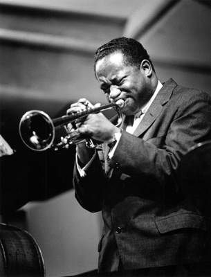 a man in a suit playing a trumpet