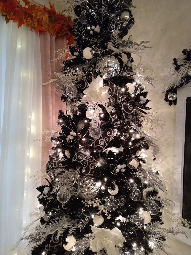 a black and white christmas tree decorated with ornaments