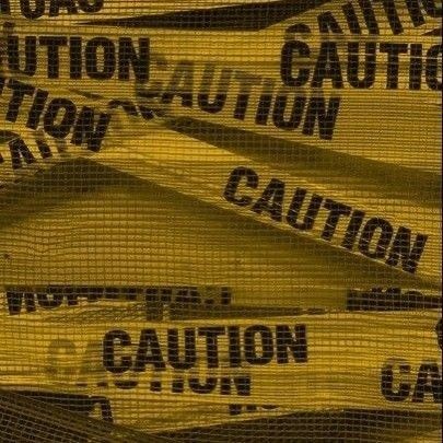 there are many caution signs on the mesh fabric that is covering the area in yellow and black