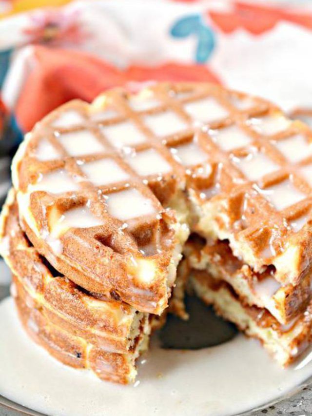 a stack of waffles sitting on top of a white plate