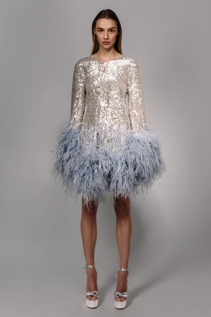 a stretch sequin cut mini dress with ostrich plumes that increase in volume as they move down the dress and sleeves   Fit: Nina is 5ft 10'' and wears a size 0 Composition: 90% polyester/10% elastane, 100% natural ostrich feathers Made in: India Christmas Party Dresses, Feather Fashion, Christmas Outfit Ideas, Funky Dresses, Derby Dress, Outfits Dress, Disco Dress, Theme Dress, Feather Trim