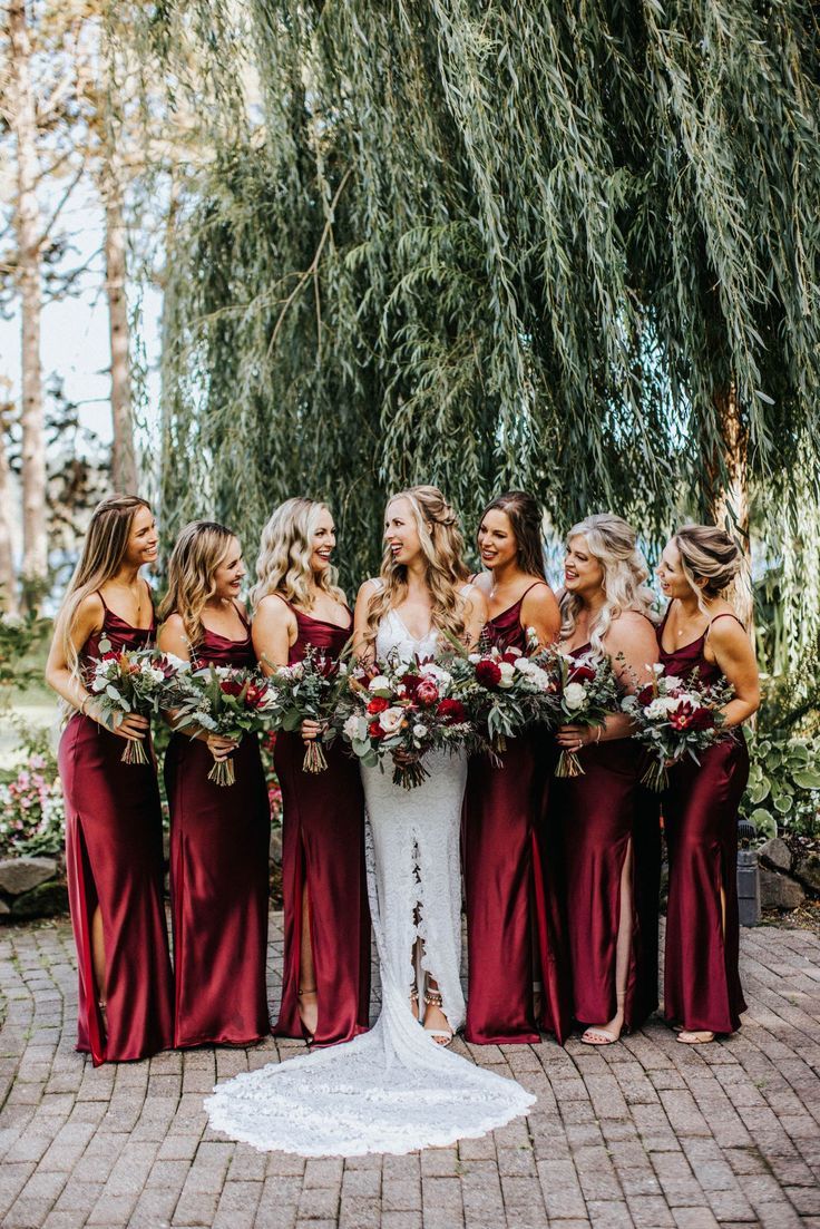 a bride and her bridal party in burgundy dresses