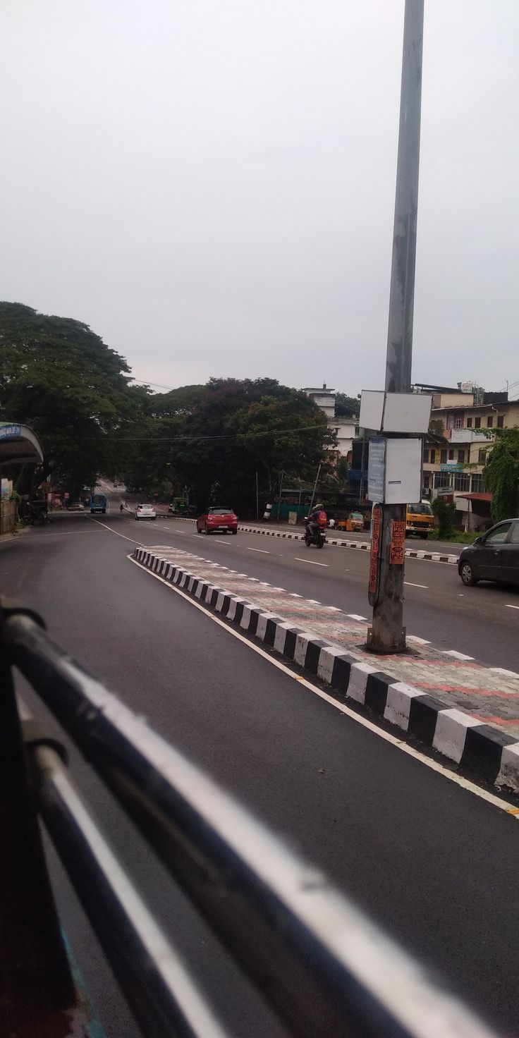 an empty street with cars driving on it