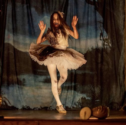 a young ballerina is dancing on stage