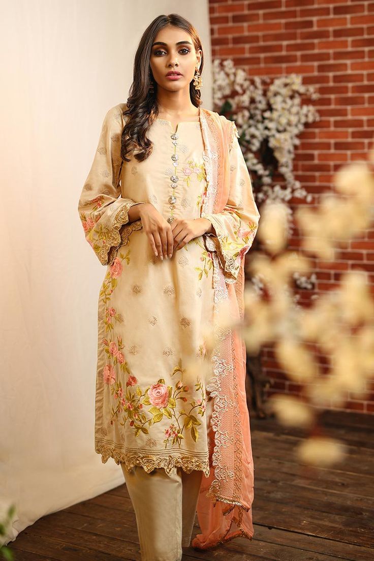 Pakistani designer lawn dress in skin color beautifully embroidered with thread work. Pakistani lawn dress is embellished with multi color thread embroidered lawn shirt. Dyed embroidered lawn shirt is paired with embroidered skin dyed sleeves. Matching color trouser in lawn fabric is added to complete your fancy look. Dupatta: Embroidered dyed dupatta in peach color is embellished with skin thread embroidery work and embroidered borders at sides. Detailed Description: SKU: P2264 Detailing: Threa Fall Collection 2022, Designer Suits Online, Salwar Suits Party Wear, Pakistani Suits Online, Pakistani Designer Suits, Summer Lawn, Sana Safinaz, Gul Ahmed, Chiffon Collection