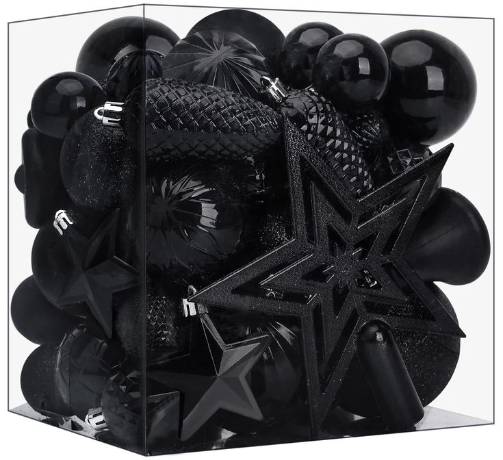 a box filled with black balloons and stars on top of each other, in front of a white background