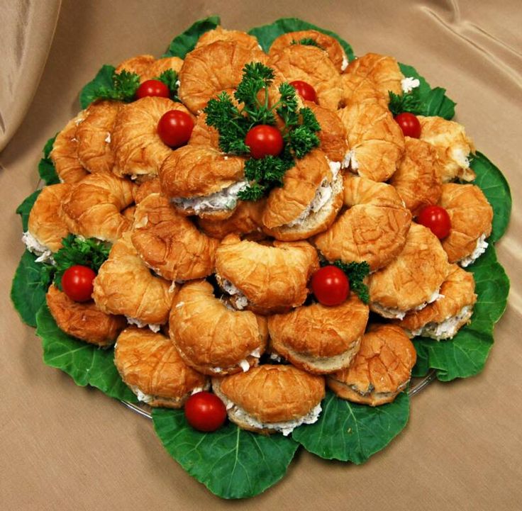 a platter filled with croissants and tomatoes