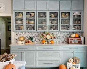 a kitchen filled with lots of furniture and decor on top of it's walls