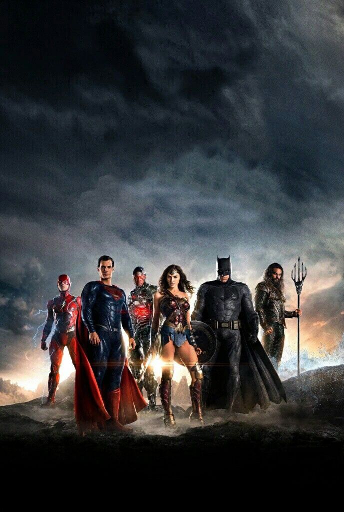 the cast of justice league standing in front of a stormy sky