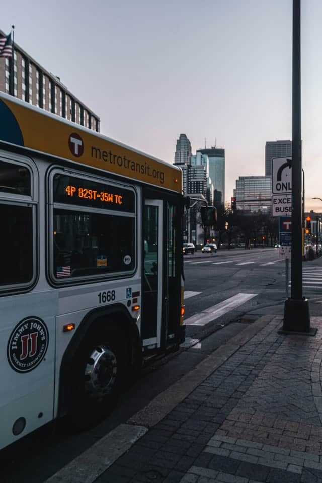 the city bus is parked on the side of the street